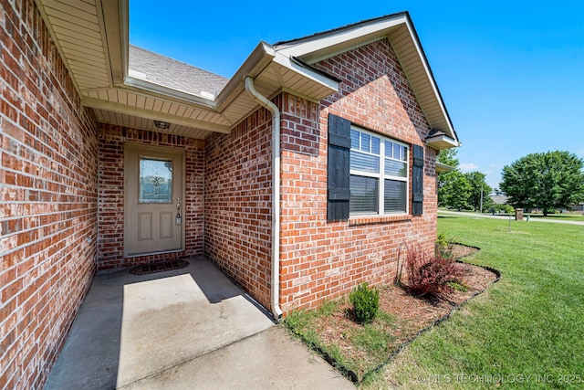 2003 Estates, Grove, OK 74344 - doorway to property with brick siding and a lawn