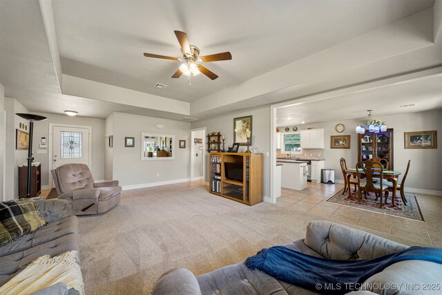 2003 Estates, Grove, OK 74344 - living area with a ceiling fan, a raised ceiling, light carpet, and light tile patterned flooring