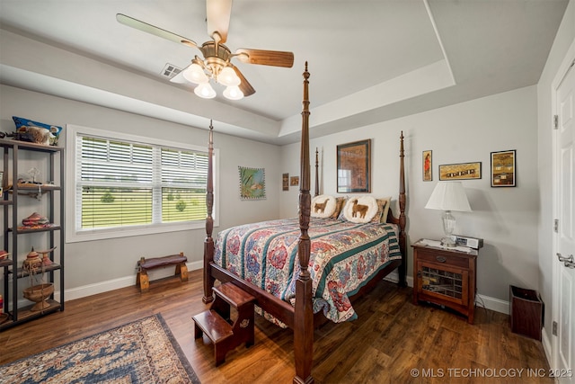 2003 Estates, Grove, OK 74344 - bedroom featuring a tray ceiling, wood finished floors, and baseboards