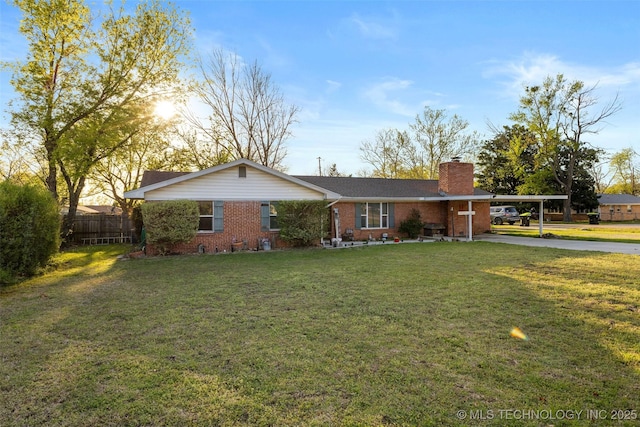 single story home featuring a front yard, fence, brick siding, concrete driveway, and an attached carport