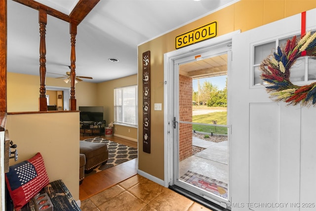 tiled entrance foyer featuring visible vents and baseboards