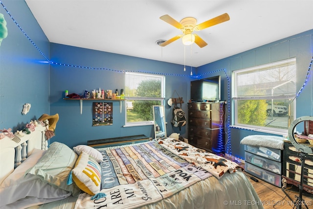 bedroom featuring wood finished floors and a ceiling fan