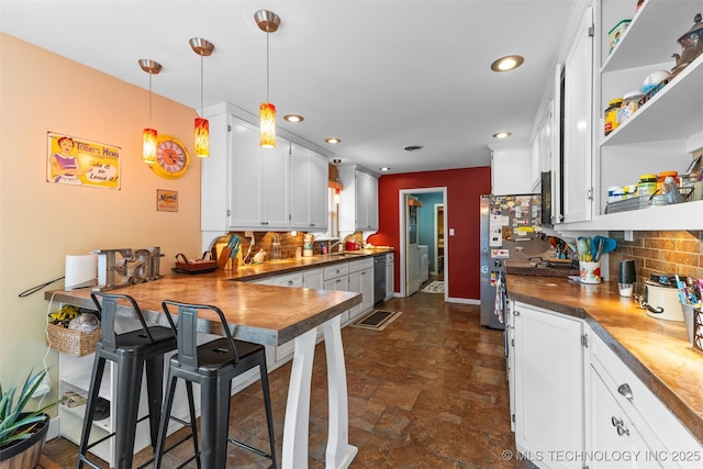 221 S Harvey, Ada, OK 74820 - kitchen featuring white cabinetry, open shelves, a peninsula, tasteful backsplash, and appliances with stainless steel finishes