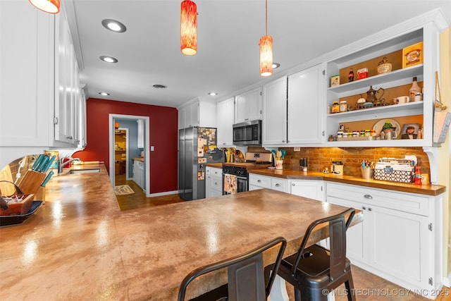 kitchen with white cabinets, a sink, open shelves, and appliances with stainless steel finishes