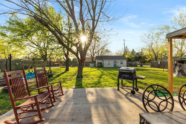 view of patio featuring a fenced backyard, a playground, and area for grilling