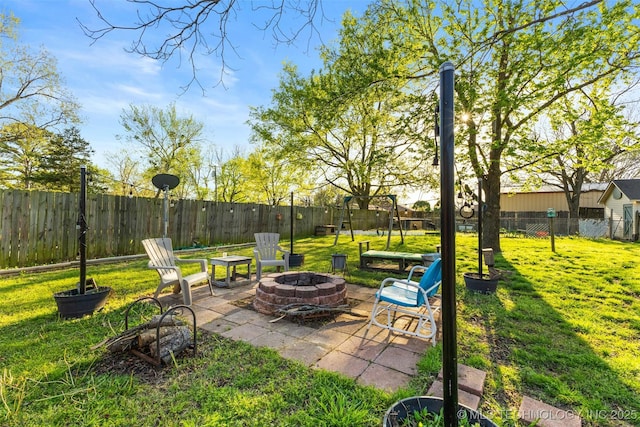 view of yard with a patio, a fenced backyard, and an outdoor fire pit
