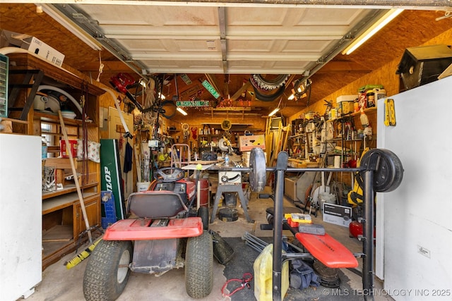 garage featuring a workshop area and water heater