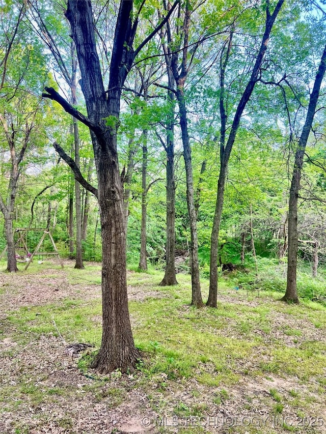 view of yard with a view of trees
