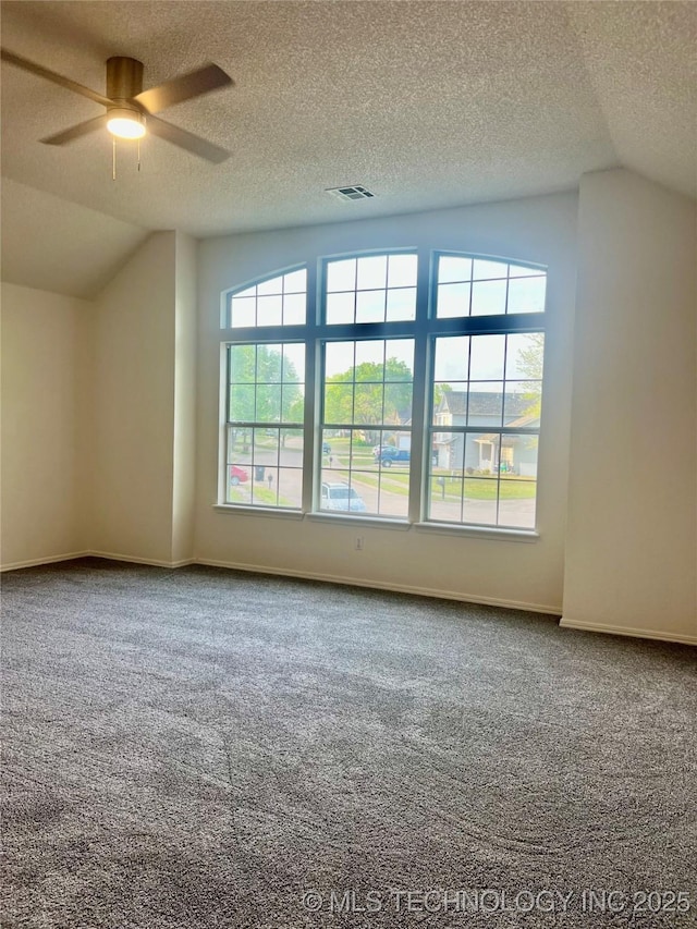 bonus room featuring ceiling fan, lofted ceiling, a textured ceiling, and carpet