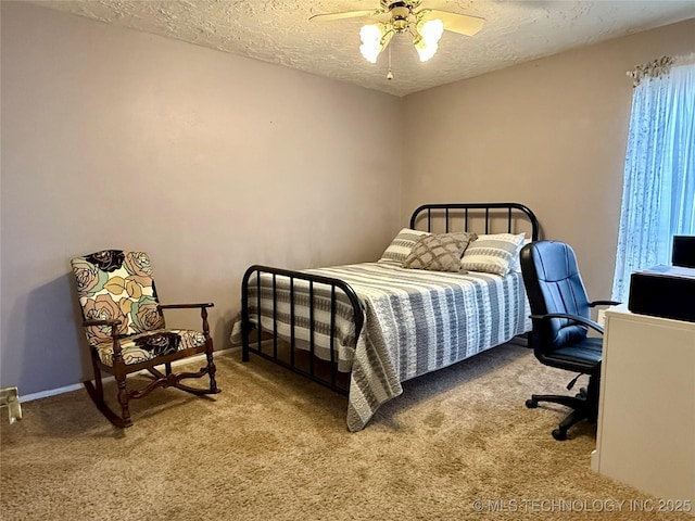 carpeted bedroom with baseboards, a textured ceiling, and a ceiling fan