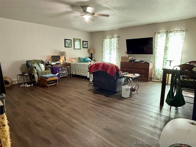 bedroom with a ceiling fan, wood finished floors, and a textured ceiling