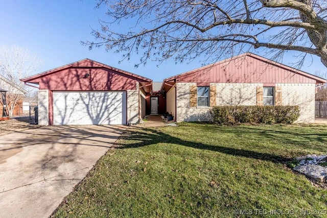 view of front of house featuring a garage, a front yard, brick siding, and driveway