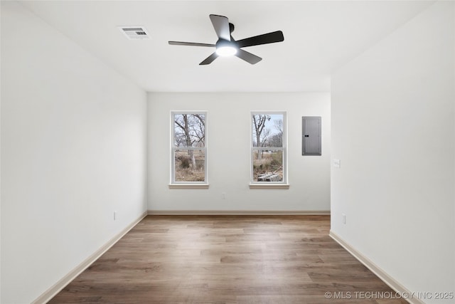 2002 W Driftwood Dr, Claremore, OK 74017 - empty room with visible vents, ceiling fan, wood finished floors, and electric panel