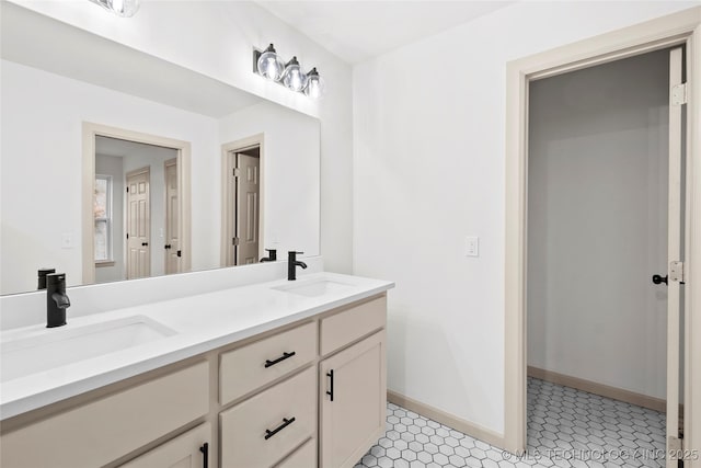 2002 W Driftwood Dr, Claremore, OK 74017 - bathroom with double vanity, a sink, and baseboards