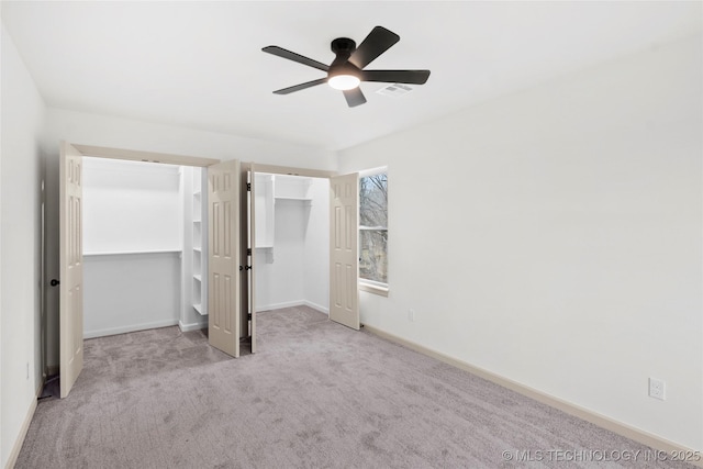 2002 W Driftwood Dr, Claremore, OK 74017 - unfurnished bedroom featuring visible vents, baseboards, ceiling fan, carpet floors, and multiple closets