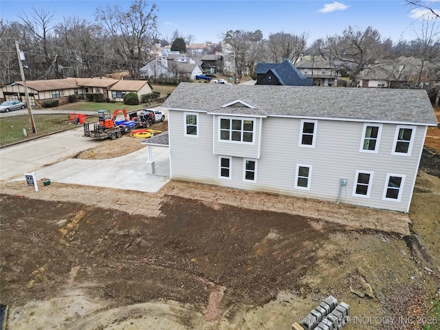 2002 W Driftwood Dr, Claremore, OK 74017 - back of house with a residential view and a shingled roof