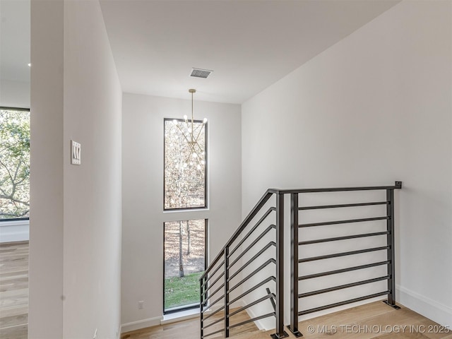 12415 Lakeview Rd, Sperry, OK 74073 - stairs with a notable chandelier, baseboards, visible vents, and wood finished floors
