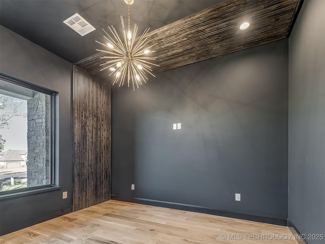 12415 Lakeview Rd, Sperry, OK 74073 - unfurnished room featuring baseboards, wood finished floors, a notable chandelier, and visible vents