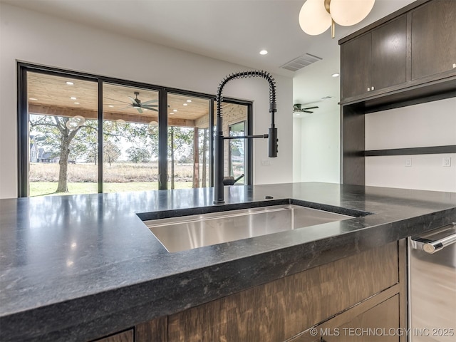 12415 Lakeview Rd, Sperry, OK 74073 - kitchen with a sink, a wealth of natural light, a ceiling fan, and dark stone countertops