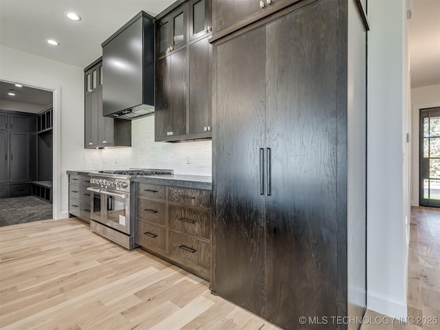 12415 Lakeview Rd, Sperry, OK 74073 - kitchen featuring tasteful backsplash, glass insert cabinets, wall chimney range hood, high quality appliances, and light wood-style flooring