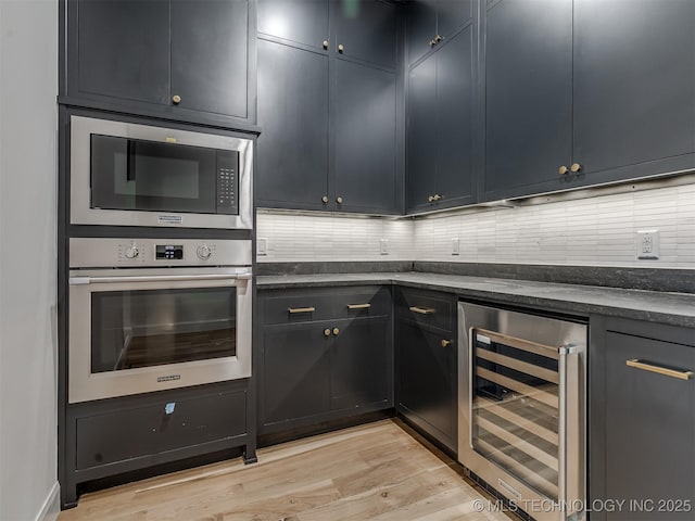 12415 Lakeview Rd, Sperry, OK 74073 - kitchen featuring dark countertops, wine cooler, stainless steel oven, backsplash, and built in microwave