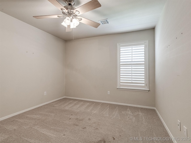empty room featuring carpet, visible vents, baseboards, and ceiling fan