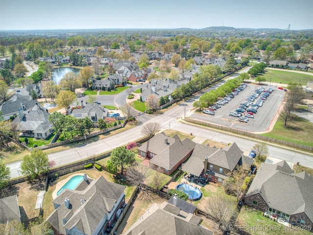 drone / aerial view with a water view and a residential view