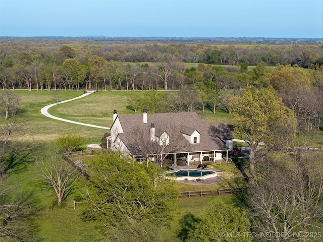 drone / aerial view featuring a forest view