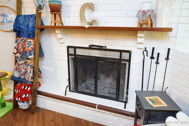 room details featuring a fireplace and wood finished floors