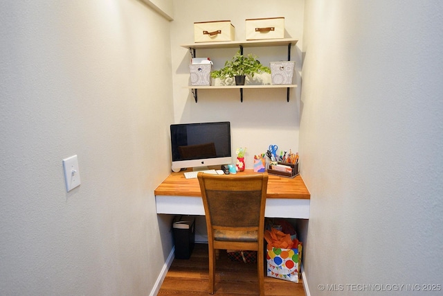 office area featuring baseboards and wood finished floors