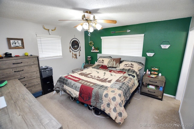 bedroom featuring carpet floors, a textured ceiling, and ceiling fan