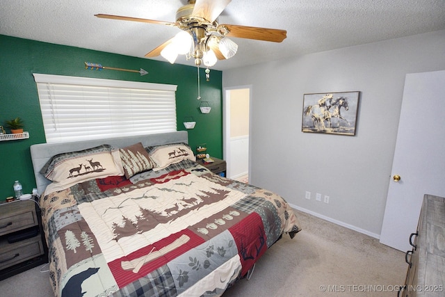 carpeted bedroom featuring a textured ceiling and ceiling fan