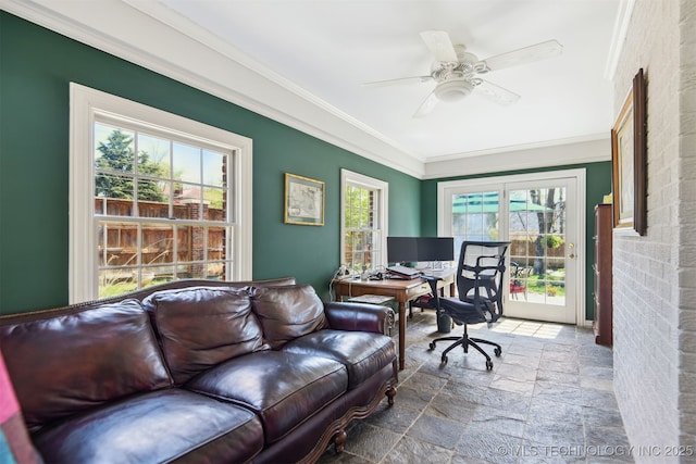 office space with crown molding, stone tile flooring, and ceiling fan