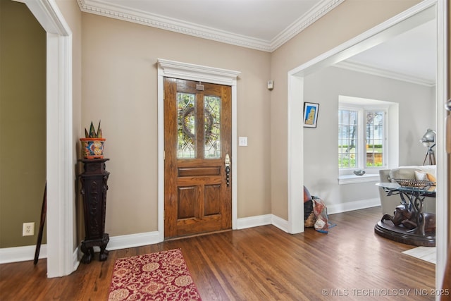 foyer entrance with baseboards, crown molding, and wood finished floors