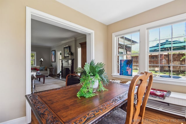 dining space with baseboards and ornamental molding