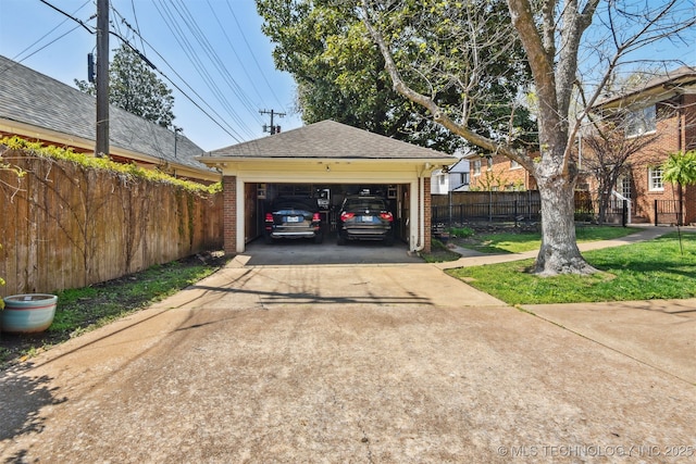 detached garage featuring fence