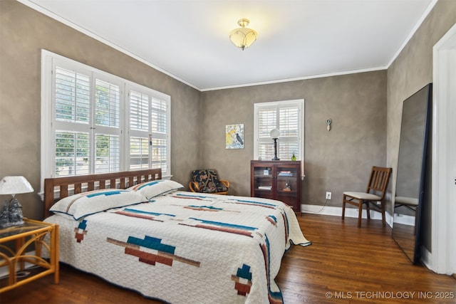 bedroom featuring crown molding, wood finished floors, and baseboards