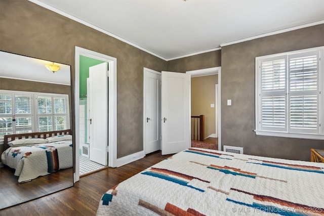 bedroom with ornamental molding, visible vents, baseboards, and wood finished floors