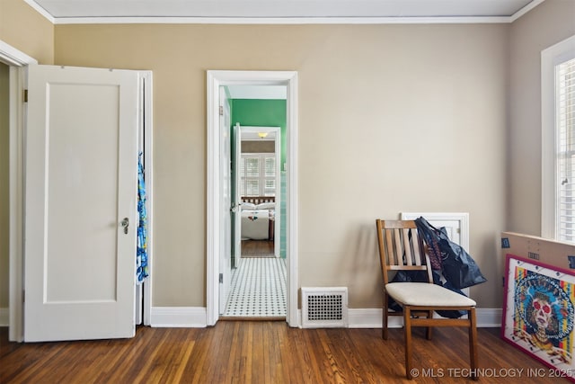 interior space with plenty of natural light, visible vents, crown molding, and wood finished floors