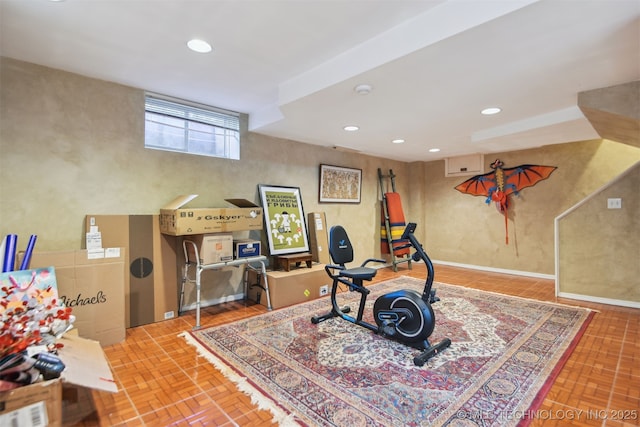 workout room featuring baseboards and recessed lighting