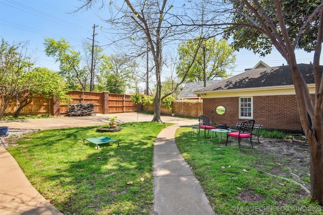view of yard featuring a patio area and a fenced backyard