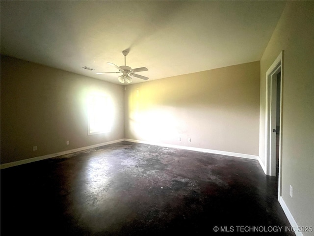 220 Willow Ln, Hartshorne, OK 74547 - empty room with unfinished concrete floors, a ceiling fan, and baseboards