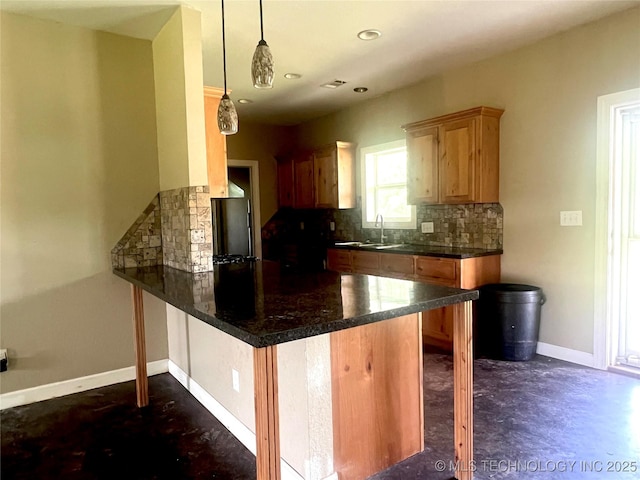 220 Willow Ln, Hartshorne, OK 74547 - kitchen featuring a peninsula, backsplash, a sink, baseboards, and pendant lighting