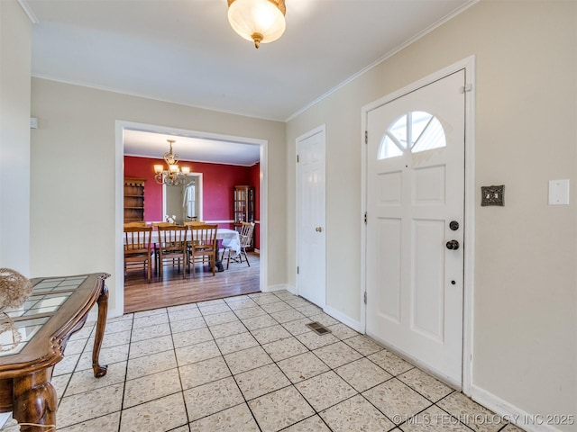 614 Oak Ridge Dr, Sand Springs, OK 74063 - entryway with light tile patterned floors, a chandelier, ornamental molding, and baseboards