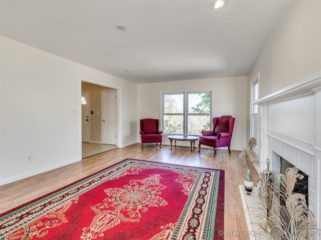 614 Oak Ridge Dr, Sand Springs, OK 74063 - living area with wood finished floors, a brick fireplace, baseboards, and recessed lighting