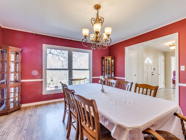 614 Oak Ridge Dr, Sand Springs, OK 74063 - dining space with healthy amount of natural light, a chandelier, ornamental molding, baseboards, and wood finished floors
