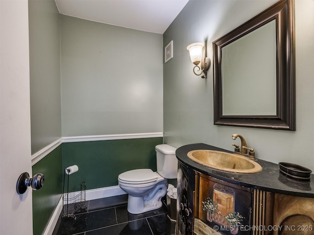 614 Oak Ridge Dr, Sand Springs, OK 74063 - half bath with tile patterned floors, toilet, vanity, and baseboards