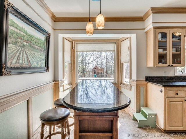 614 Oak Ridge Dr, Sand Springs, OK 74063 - dining area featuring plenty of natural light, crown molding, a decorative wall, and wainscoting