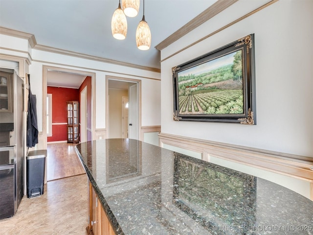 614 Oak Ridge Dr, Sand Springs, OK 74063 - kitchen featuring dark stone countertops, light wood-style floors, pendant lighting, and crown molding