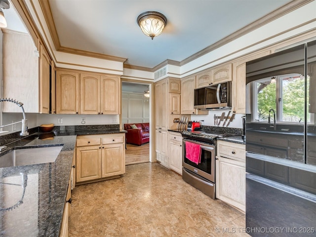 614 Oak Ridge Dr, Sand Springs, OK 74063 - kitchen featuring stainless steel appliances, light brown cabinetry, a sink, ornamental molding, and dark stone counters